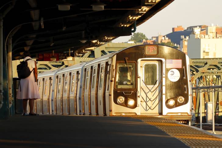 An F train pulls into a Brooklyn subway station.